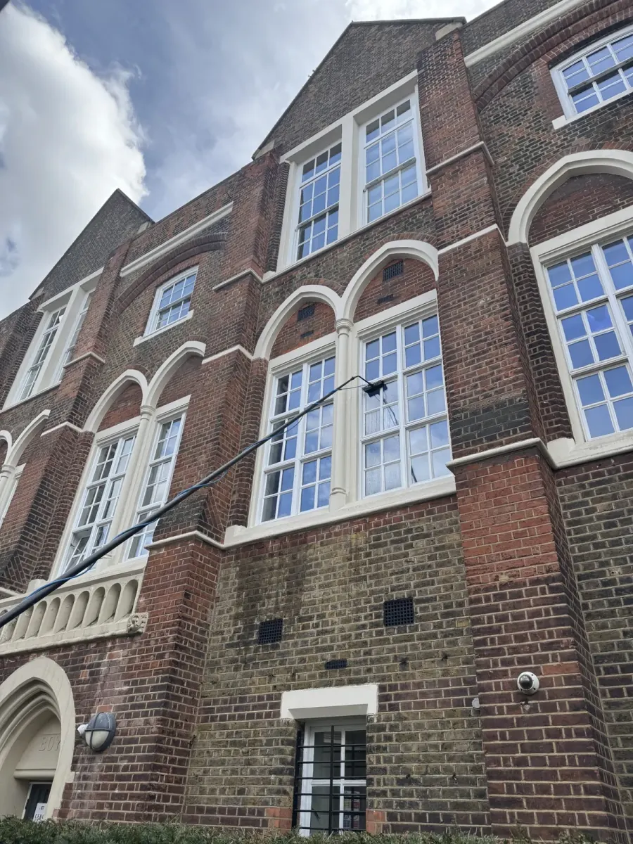 Arched sash windows on a red brick period building, cleaned and left streak-free