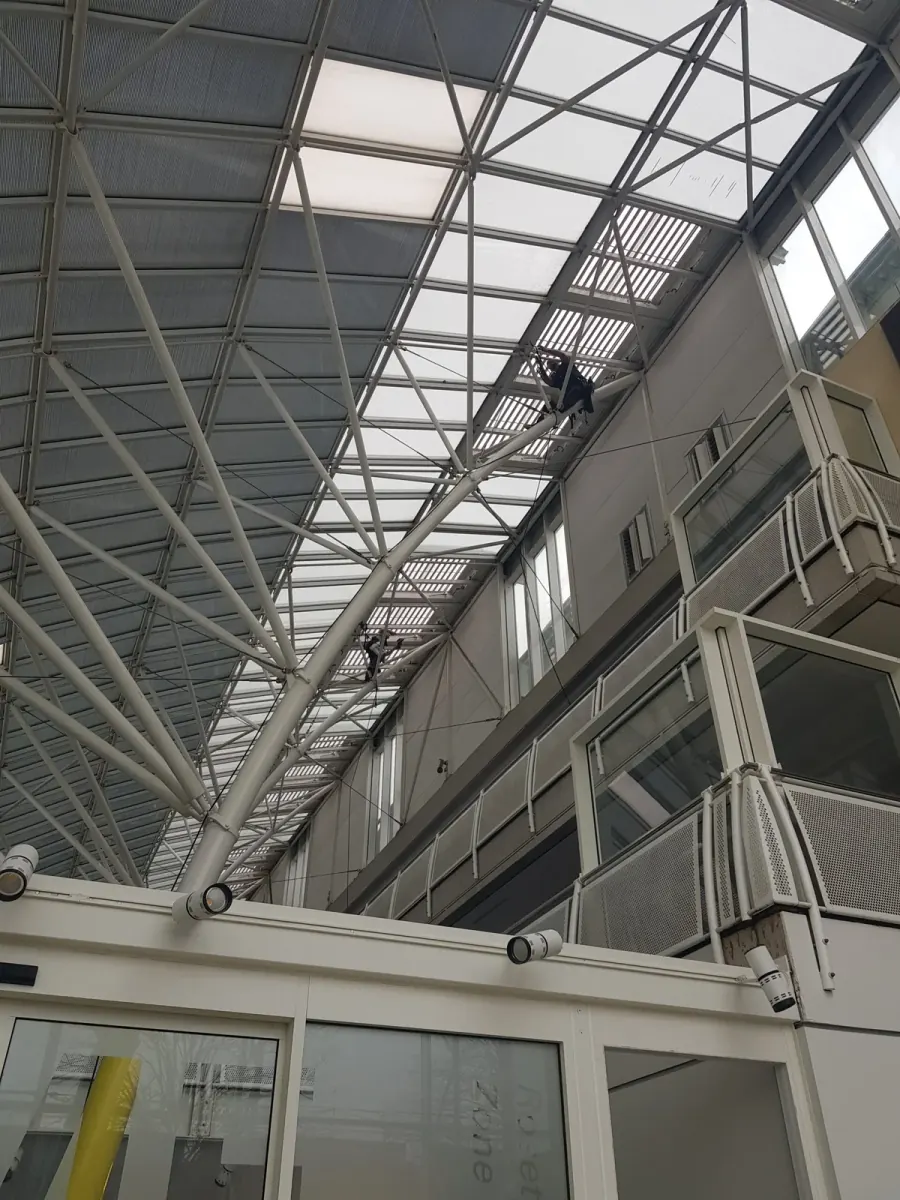 Overhead glazing inside a commercial building, cleaned to let the daylight back through